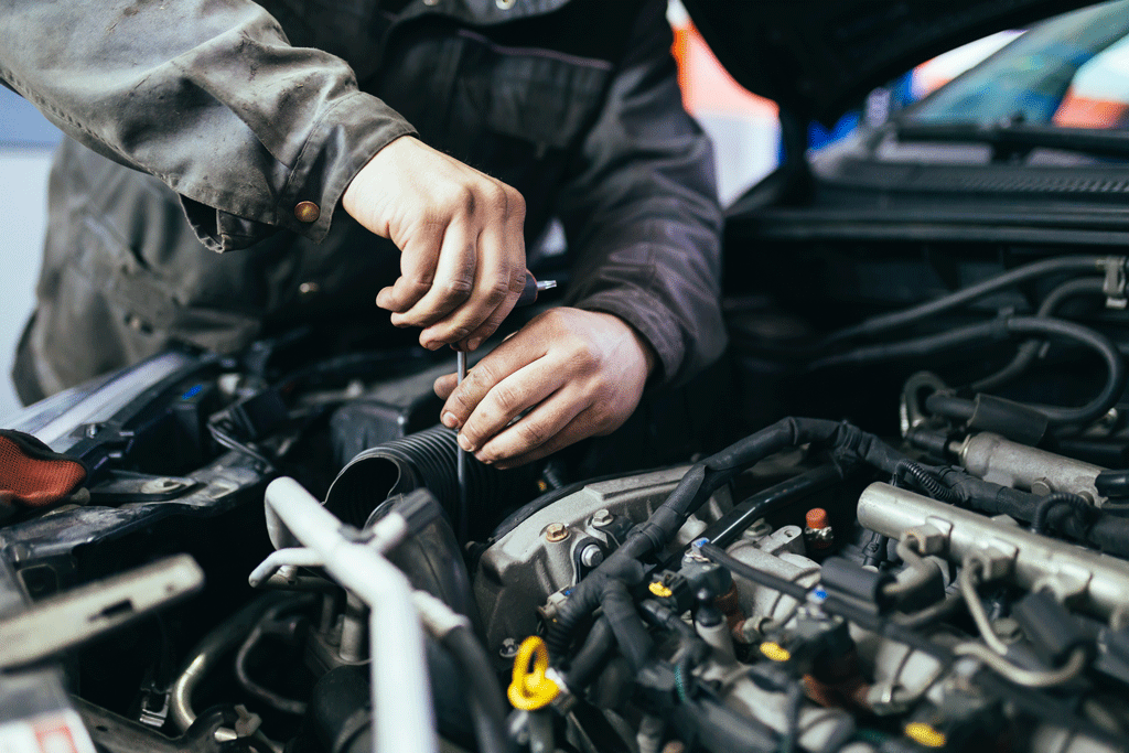 auto mechanic using tool inside engine Automotive Maintenance gretna la harvey la